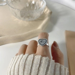 Close-up of S925 sterling silver heart ring with Japanese engraving in cozy setting