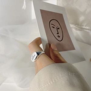 Vintage S925 sterling silver oval signet ring featuring engraved Love script on a model