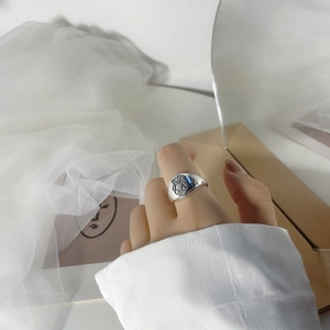 Close-up of S925 sterling silver signet ring featuring a cute cartoon teddy bear engraving