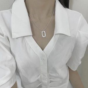 Detail of S925 silver square hollow pendant with textured finish on a ball chain