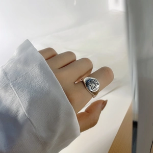 Detail of S925 sterling silver ring with cute bear engraving on a polished signet top