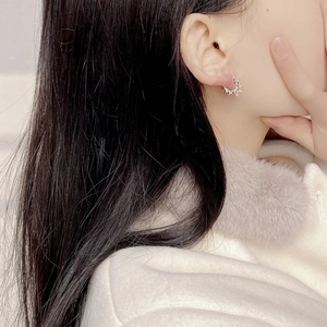 925 Sterling silver twisted spike hoop earrings worn by a model in silver finish