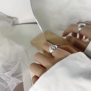 Artistic mirror reflection of S925 sterling silver teddy bear signet ring on a model hand