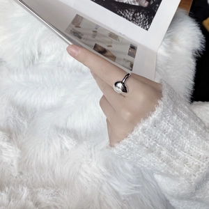 Polished S925 sterling silver water drop ring on a hand with a fashion magazine backdrop