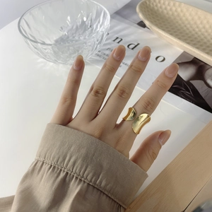 Minimalist gold irregular geometric open ring with smooth metallic luster on hand