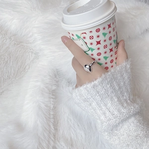 Minimalist S925 sterling silver waterdrop ring shown in a cozy winter lifestyle setting