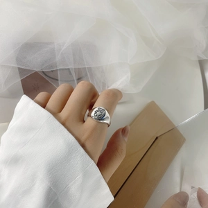 Close-up of S925 sterling silver ring with minimalist cartoon bear engraving on round face