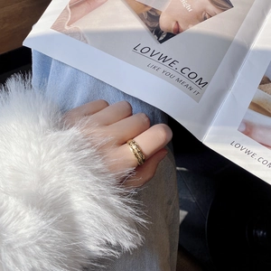 Gold moon shape ring with hammered texture worn with faux fur and denim fabric