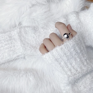 Minimalist S925 sterling silver teardrop ring worn on hand with cozy knitwear background