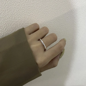 Minimalist S925 sterling silver smile ring with engraved lettering worn on index finger