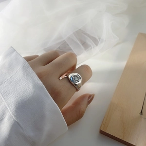 Polished S925 sterling silver wide ring with a cute engraved teddy bear on a model's finger