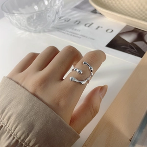 Detail of minimalist liquid lava sterling silver ring with organic flowing texture