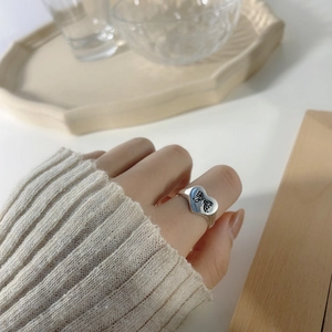 S925 sterling silver heart ring with black bow engraving shown on finger