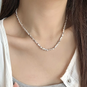 Minimalist 925 sterling silver necklace with faceted silver nuggets on a female model