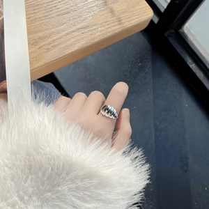 French vintage S925 sterling silver croissant ring with spiral texture on a wooden desk
