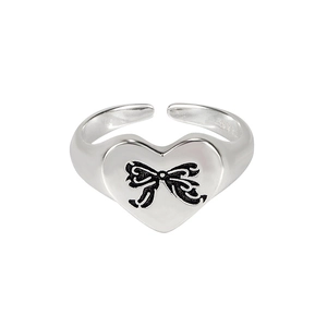 Minimalist S925 sterling silver heart ring with black bow design on white background