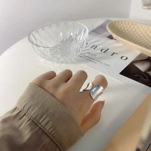 Close-up of irregular 925 sterling silver open ring on hand with glossy finish