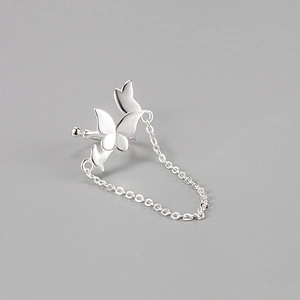 Macro view of S925 sterling silver bow ear cuff with delicate hanging tassels
