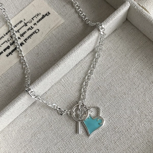 Macro detail of S925 silver heart pendant with blue enamel and OT toggle clasp