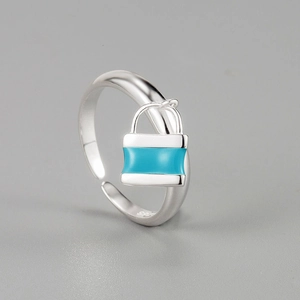 Detailed shot of S925 sterling silver ring featuring a blue enamel lock charm and S925 stamp