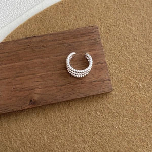 Detail of twisted S925 sterling silver ear cuff showing the engraved silver hallmark