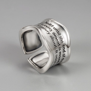 Macro shot of S925 sterling silver wide ring featuring engraved punk graffiti lettering