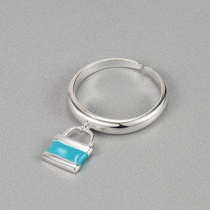 Detailed view of S925 silver ring featuring a blue enamel padlock pendant and open band