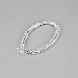 Detail of S925 sterling silver chain bracelet featuring textured wire-wrapped coils and OT buckle