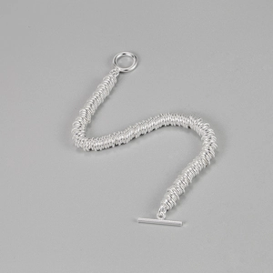 Detail of S925 silver link chain bracelet with unique spring-coil texture and OT toggle clasp