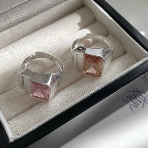 Macro detail of S925 silver rings with rectangular pink and orange zircon stones