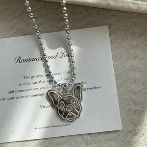 S925 sterling silver pug dog pendant necklace on white card and beige fabric background