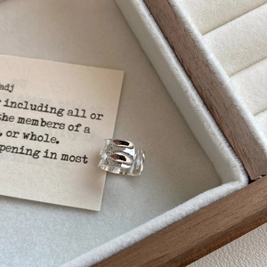 Detailed macro shot of S925 sterling silver ring with irregular hammered texture finish