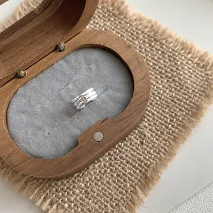 Silver multi-layer cuff ring with horizontal grooves in a wooden jewelry gift box
