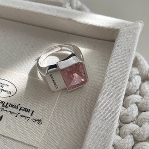 Macro view of 925 sterling silver ring with rectangular pink zircon and side engraving