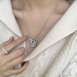 Close-up of S925 silver French Bulldog pendant with textured details on a bead chain
