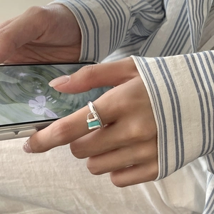 S925 sterling silver open ring featuring a mint green enamel lock pendant on model's hand