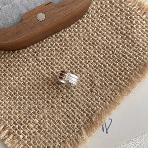 925 sterling silver triple-layer ear cuff earring on rustic linen and wood background