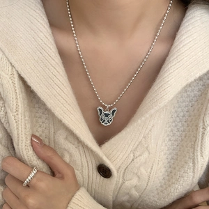 S925 sterling silver pug dog necklace and twisted ring set on white knit sweater