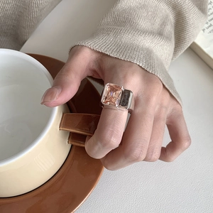 Detail of 925 silver ring with large rectangular champagne zircon worn on hand