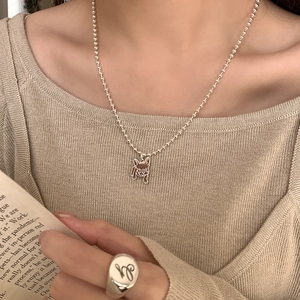 Collier avec pendentif carlin en argent 925 et chevalière portés par un mannequin
