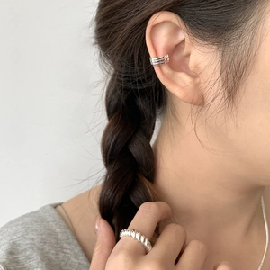 Detail view of 925 silver triple line ear cuff and twisted rope ring on a model