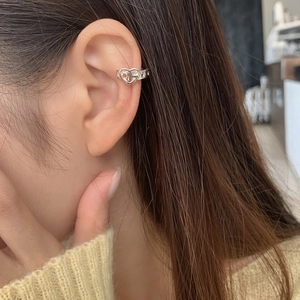 Close-up of S925 sterling silver double heart ear cuff worn on the middle ear lobe