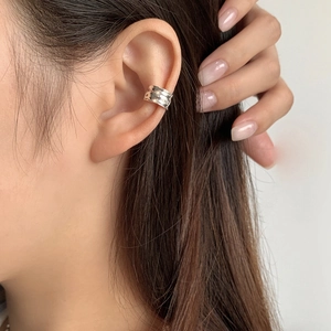 Minimalist S925 sterling silver ear cuff with irregular hammered texture on model