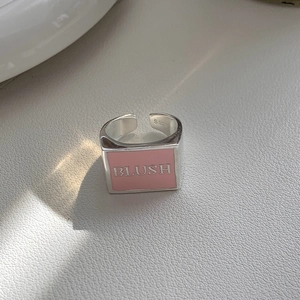 Detailed macro view of S925 sterling silver ring with pink enamel and BLUSH engraving