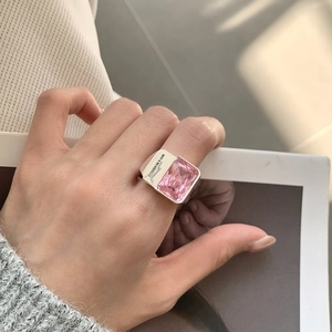 Detail of 925 sterling silver ring with pink rectangular zircon and side engraving