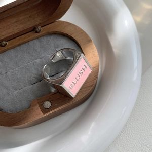 Detailed macro view of S925 sterling silver ring with pink enamel and BLUSH engraving