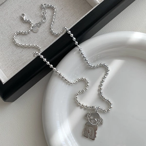 Detail of S925 silver beaded necklace with poodle pendant and adjustable lobster clasp