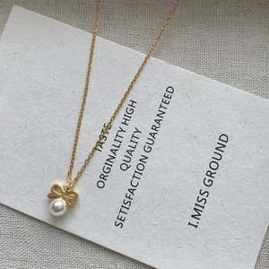Elegant S925 silver bow pendant necklace with round white pearl on a gold chain