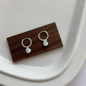 Detailed view of S925 sterling silver heart earrings with moonstone and twisted texture