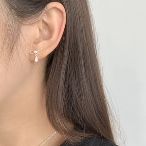 Elegant S925 sterling silver bow knot earrings with water drop zircon on female model